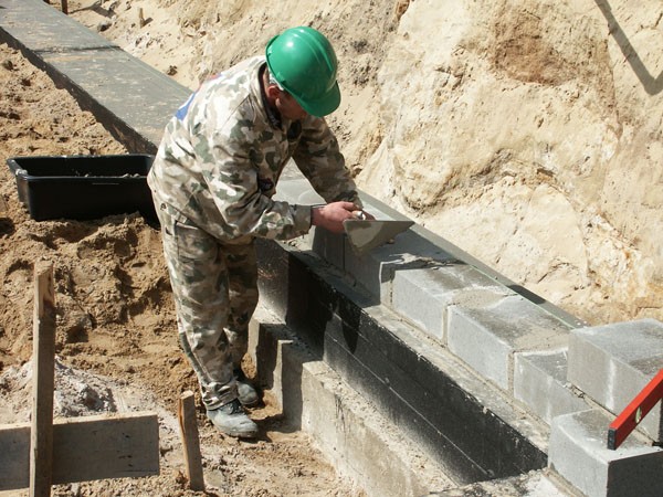 Murowanie ścian fundamentowych z bloczków betonowych. Fot. ATLAS